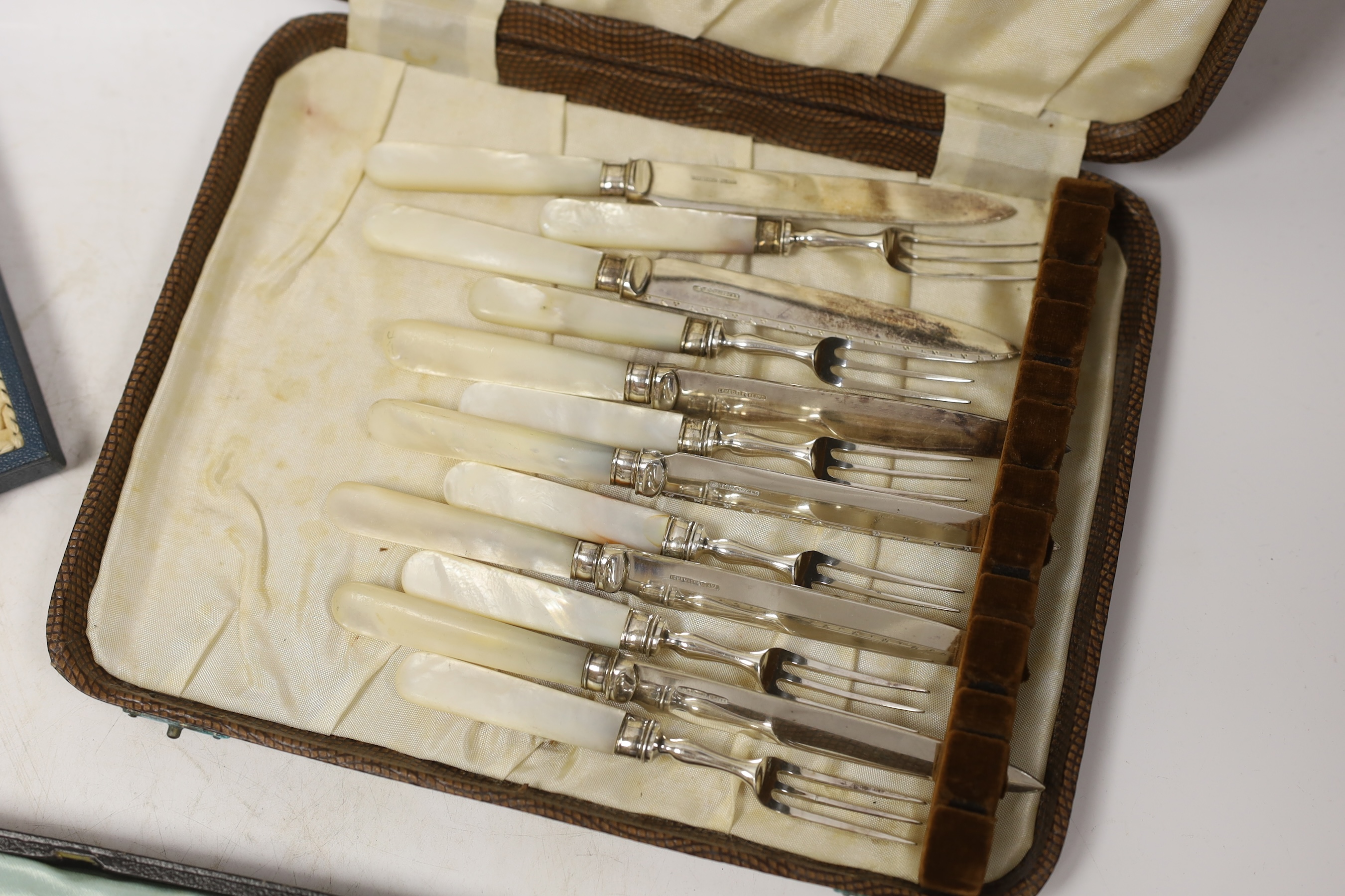 Four assorted cased cutlery sets including a set of twelve Norwegian gilt 925 and guilloche enamel coffee spoons.